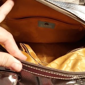 Silver pocketbook with soft gold lining.